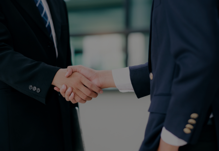 Image depicts a closeup of a handshake