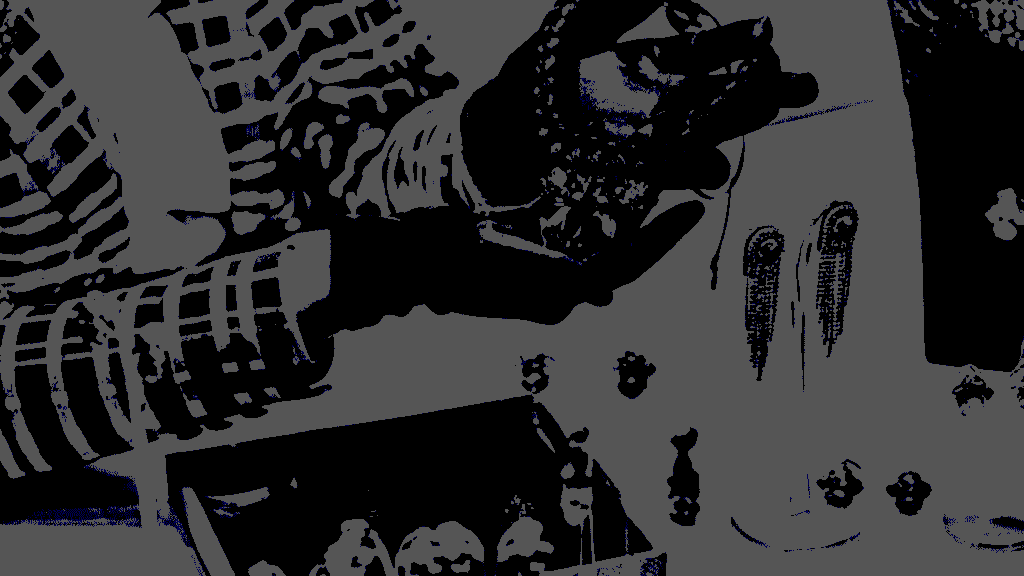 gloved hands holding a piece of jewelry