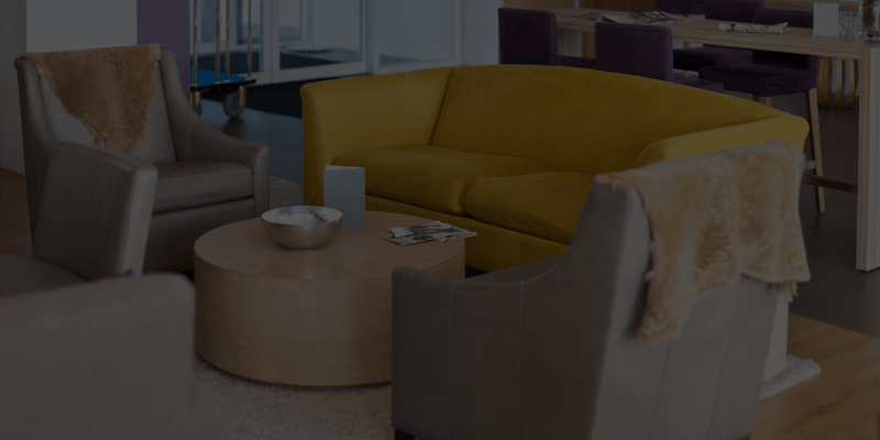 a cozy scene with three couches; one yellow, and others, brown