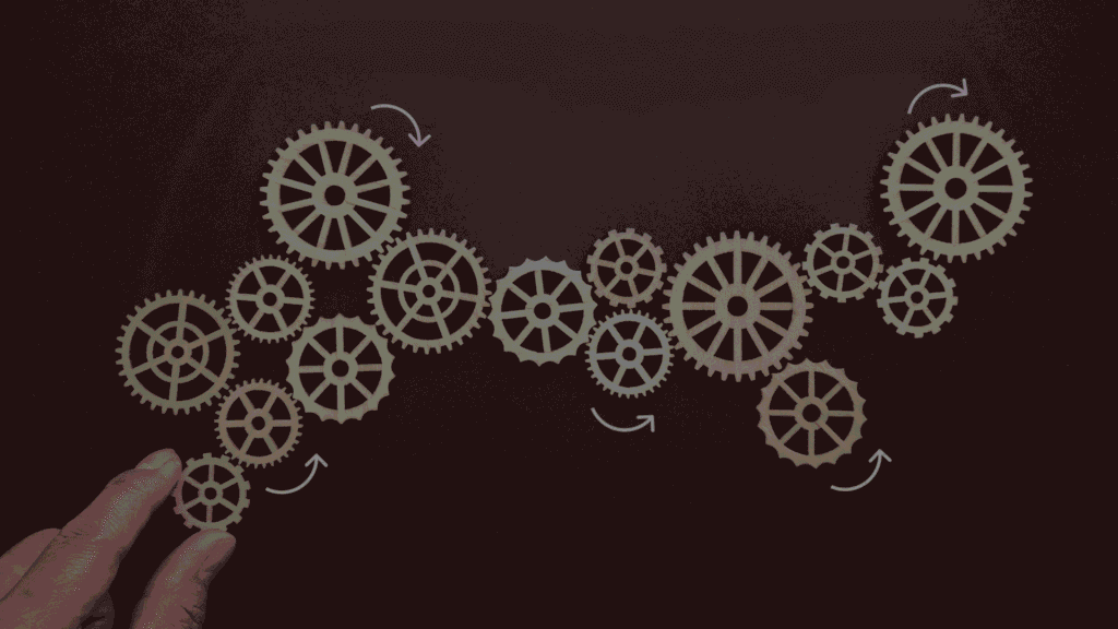 fingers holding onto small gears
