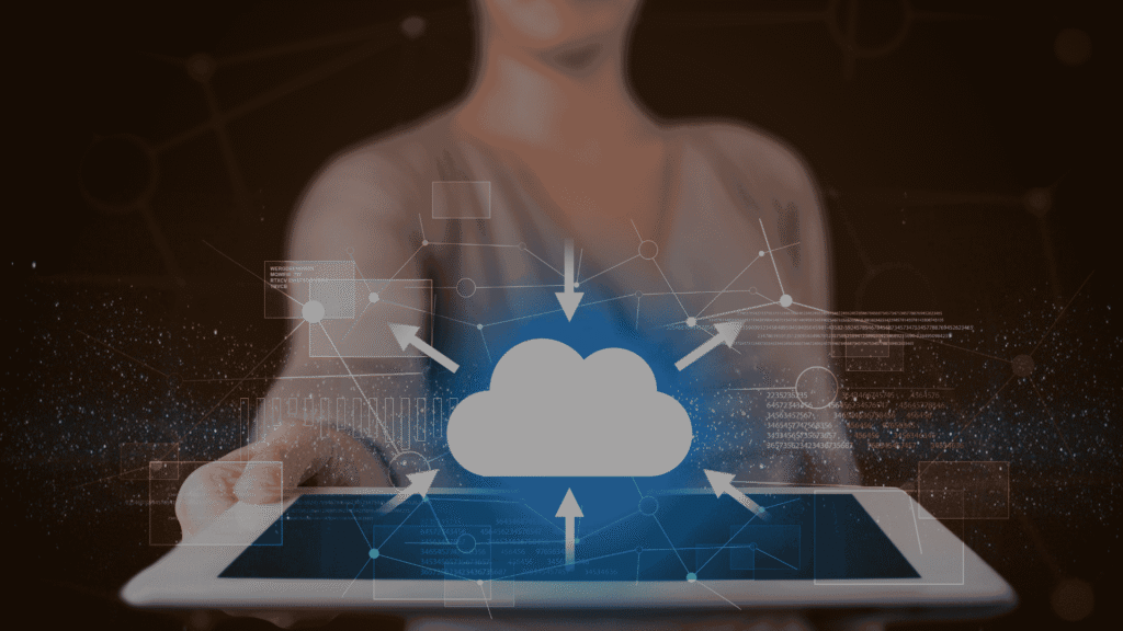 Person holding a tablet displaying a cloud computing graphic with arrows, network connections, and digital data overlays representing cloud technology and data exchange