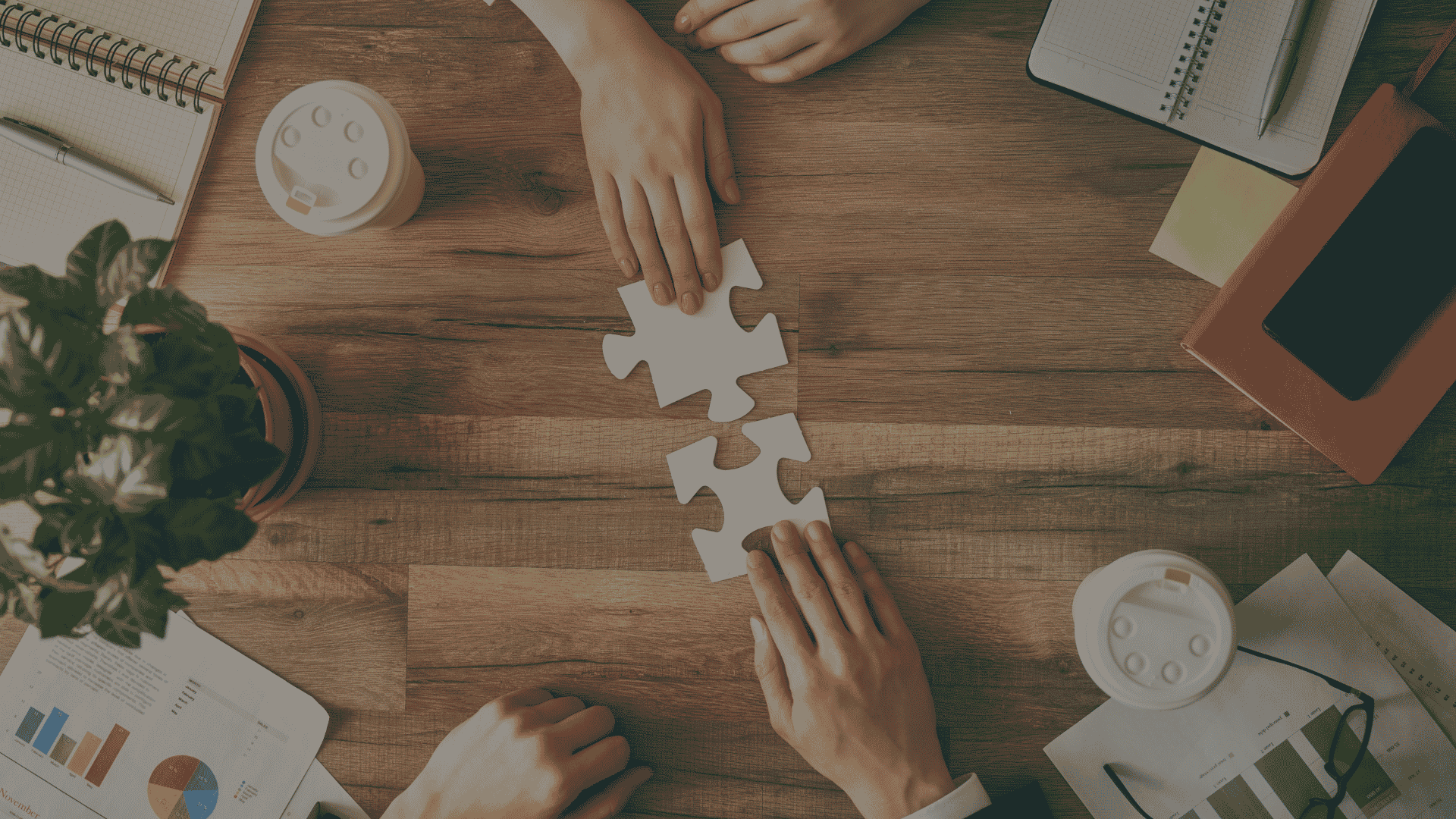 Business professionals connecting puzzle pieces, symbolizing collaboration, integration, and strategic problem-solving.